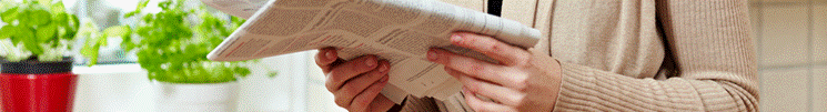 Image of a person reading a newspaper